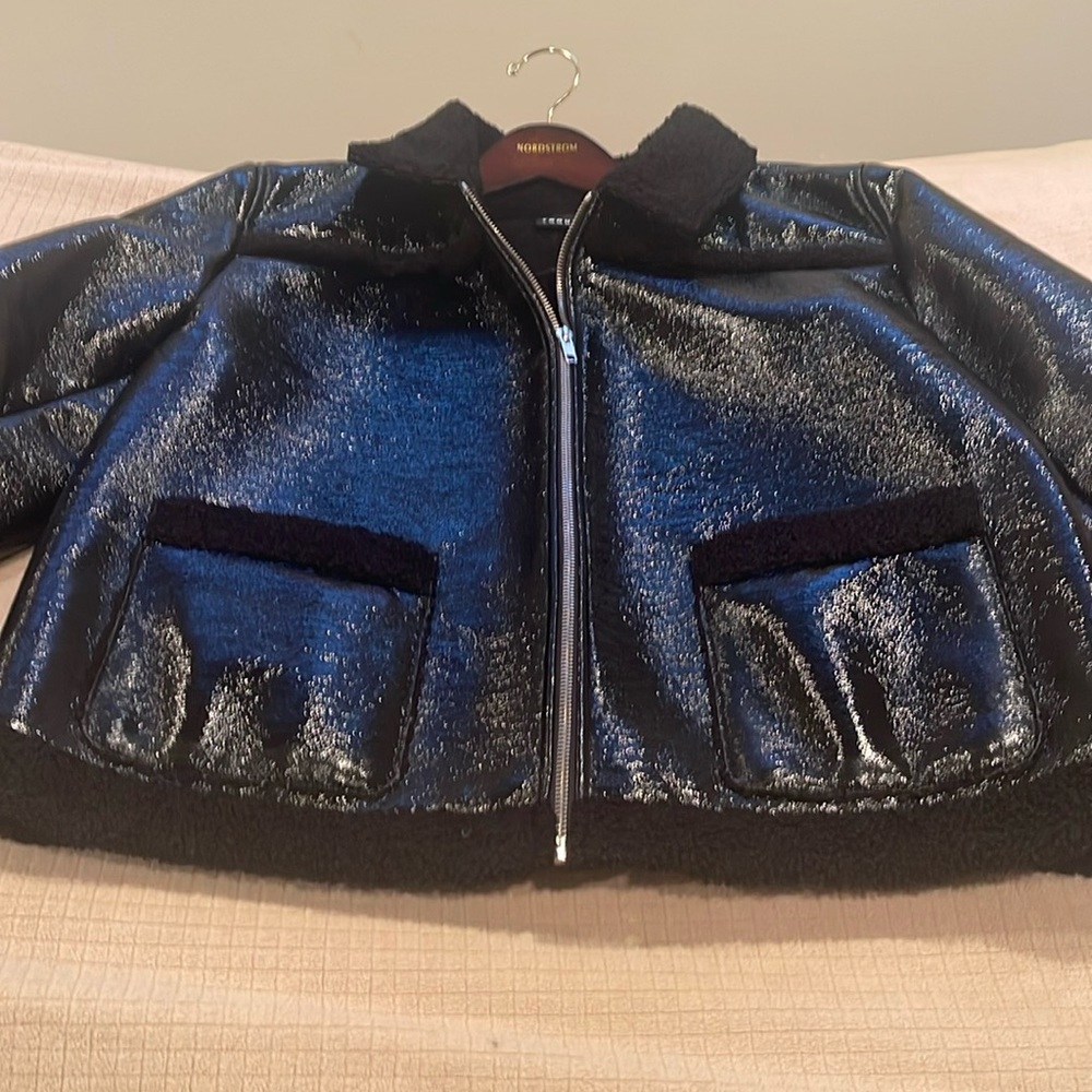 Woman’s black short Patent Leather Jacket. Mint condition, lightly worn.
